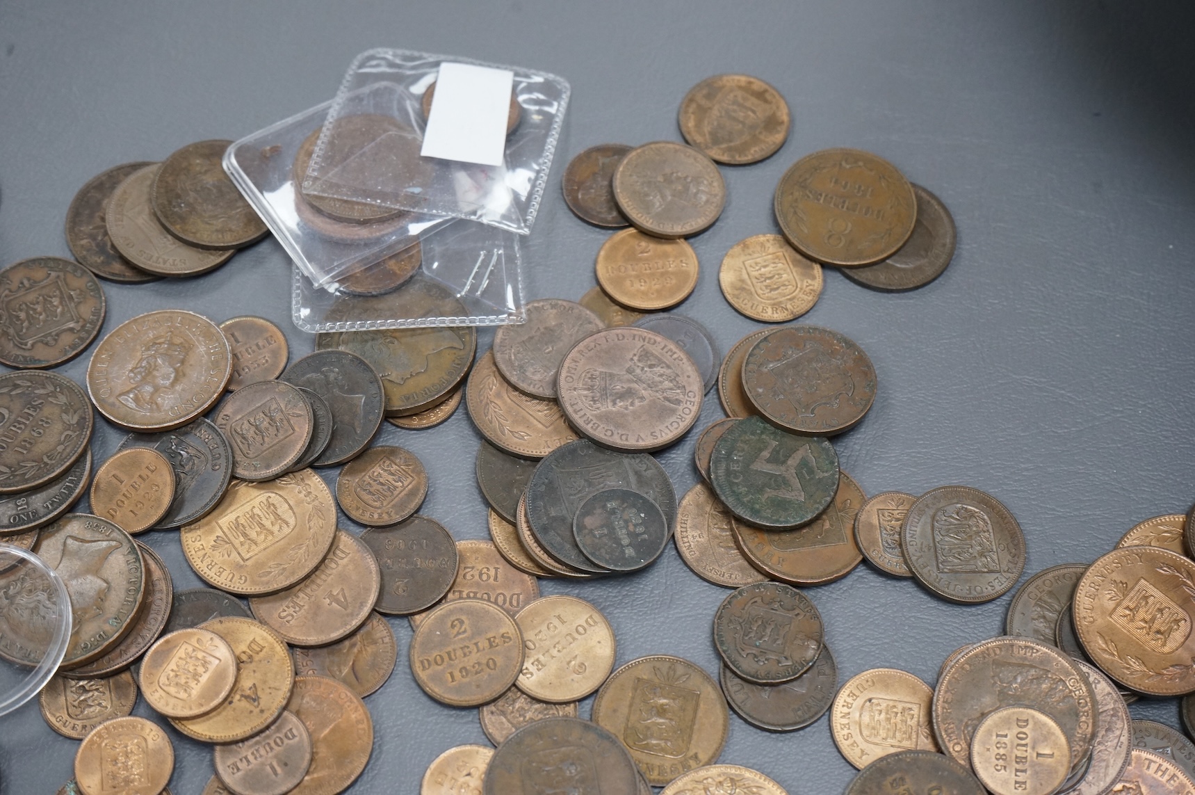 A collection of Guernsey and Channel Islands coins, Victoria to George V, many EF to UNC, Together with a C. Brooke rajah Sarawak, one cent, 1870, about EF